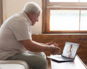 man on a video call while sitting on a sofa